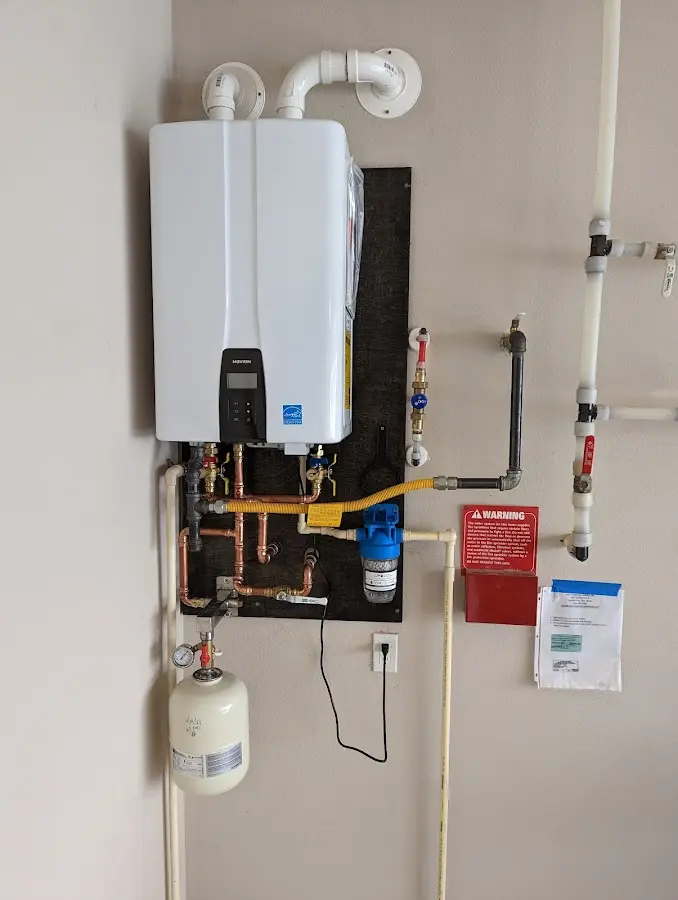 Professional plumber installing copper piping in a Wilson's Mills home